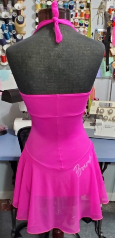 back view of pink Barbie themed figure skating dress