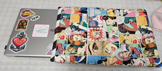 padded computer sleeve made from comic book themed fabric