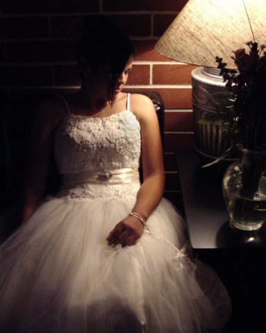 Bride in shadow wearing a bridal gown with a full tulle skirt