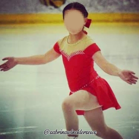 skater wearing red Annie themed figure skating dress