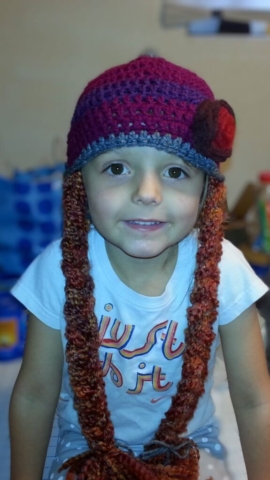 crocheted Anna hat from frozen with flower detail and braids