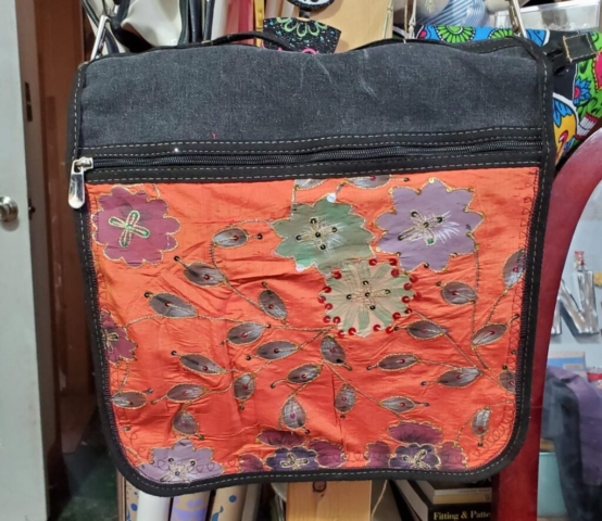 Upcycled messenger bag with orange embroidered silk flap