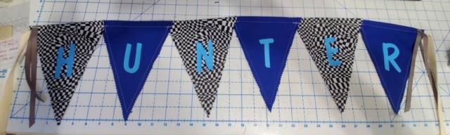 Name bunting out of blue and checkerboard fabrics