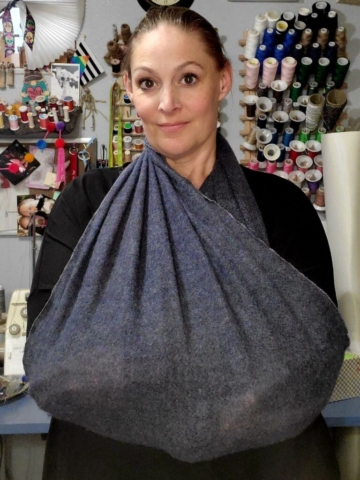 woman with arms wrapped inside of travel infinity scarf