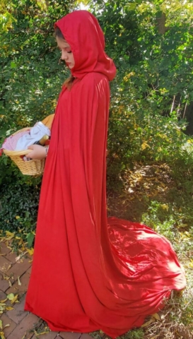 girl wearing a red riding hood cape