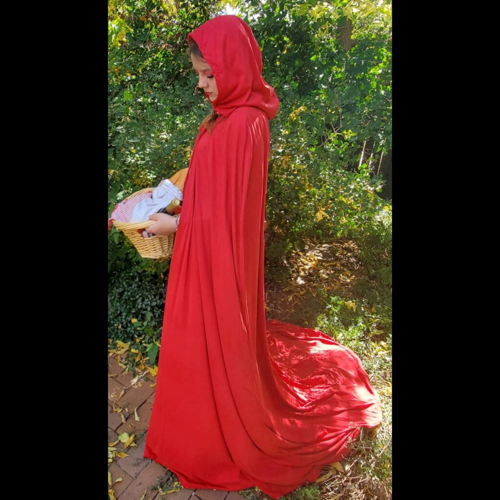 Girl wearing long red cloak