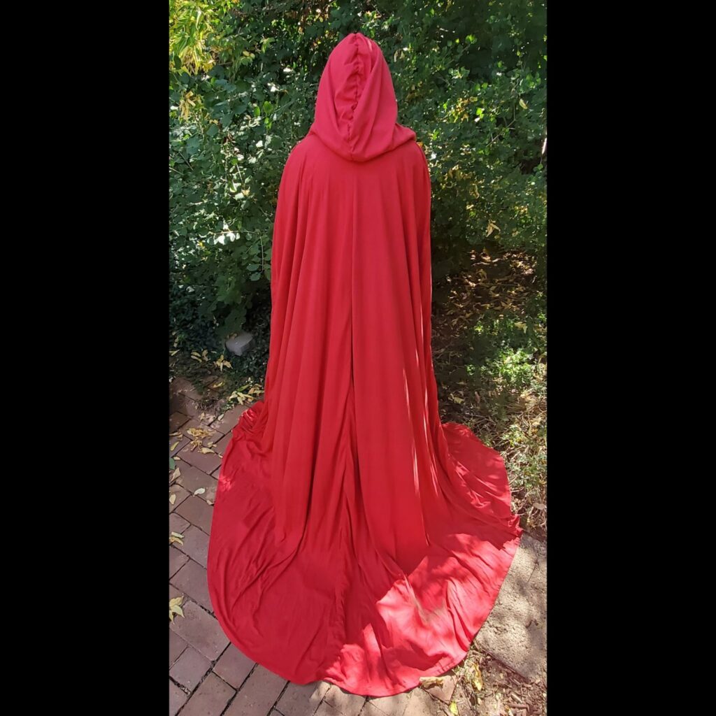 Girl wearing long red cloak