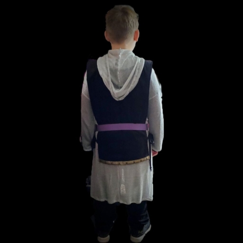 back view of a boy wearing a knight costume