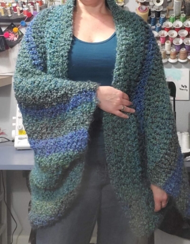 woman wearing blue and green crocheted sweater shrug