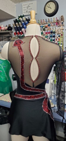 Black figure skating dress with red appliqued snakes