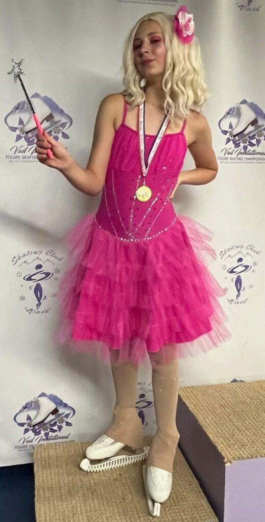 Girl wearing Glinda skating costume