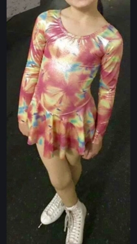 girl wearing a tie dyed figure skating dress